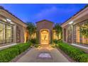 Charming entrance with manicured landscaping and decorative accents at twilight at 5162 Estasi St, Las Vegas, NV 89135