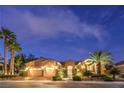 Inviting home exterior featuring a well-maintained lawn and tasteful landscaping at night at 5162 Estasi St, Las Vegas, NV 89135