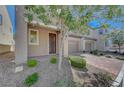 Attractive home featuring desert landscaping, brick paved driveway and walkway, and a covered entryway at 5244 Fiery Sky Ridge St, Las Vegas, NV 89148