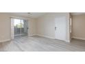 Inviting living area with vinyl floors and balcony access for seamless indoor-outdoor living at 555 E Silverado Ranch Blvd # 2164, Las Vegas, NV 89183