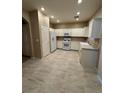 Bright kitchen features white appliances, ample cabinets, and marble-like flooring at 5861 Varese Dr, Las Vegas, NV 89141