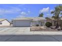 Charming single-story home with a tiled roof, desert landscaping, and a spacious two-car garage at 5990 Ablette Ave, Las Vegas, NV 89122