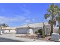 Lovely home with tiled roof, desert landscaping, two-car garage and mature palm trees at 5990 Ablette Ave, Las Vegas, NV 89122
