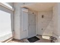 Inviting front porch with security screen door and sun shades for added privacy at 5990 Ablette Ave, Las Vegas, NV 89122