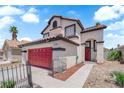 Charming two-story home features a red garage door, a tile roof, an arched entry and drought resistant landscaping at 6374 Horizon Ridge Ct, Las Vegas, NV 89156