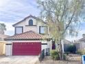 Charming two-story home with a red garage door, red tile roof and well-maintained landscaping at 6374 Horizon Ridge Ct, Las Vegas, NV 89156