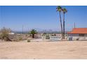 Desert backyard with small pool and distant city views at 6727 E Washington Ave, Las Vegas, NV 89110