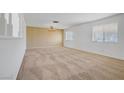 Spacious carpeted living room with chandelier and natural light at 6727 E Washington Ave, Las Vegas, NV 89110