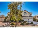 Well-maintained home features mature trees, a three-car garage, and manicured landscaping at 6971 Cedar Basin Ave, Las Vegas, NV 89142