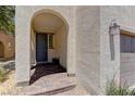 Covered entrance with brick flooring, and a textured stucco wall at 7104 Flathead River Ave, Las Vegas, NV 89179
