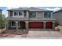 Charming two-story home with stone accents, three-car garage and brick paved driveway at 7255 Bold Rock Ave, Las Vegas, NV 89113
