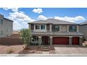 Attractive two-story home with stone accents, three-car garage and desert landscaping at 7255 Bold Rock Ave, Las Vegas, NV 89113