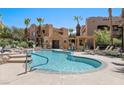 Inviting community pool with a tanning deck and desert landscaping, ideal for summertime relaxation at 728 Hardy Way # E, Mesquite, NV 89027