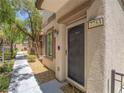 Close up of a townhome front door with a landscaped walkway leading to a welcoming entrance at 7753 Petite Pillar Ct, Las Vegas, NV 89149