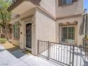 Charming townhome entrance with a private patio, offering a welcoming curb appeal at 7753 Petite Pillar Ct, Las Vegas, NV 89149