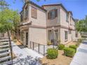 Inviting townhome featuring a cozy front patio area, perfect for outdoor relaxation and enjoyment at 7753 Petite Pillar Ct, Las Vegas, NV 89149