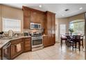 Well-appointed kitchen featuring stainless steel appliances, tile floors, and a cozy breakfast nook at 805 Palmero Way, Boulder City, NV 89005