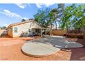 Spacious backyard with a large concrete patio and a covered seating area, perfect for outdoor entertaining at 8505 Lansdale Rd, Las Vegas, NV 89123
