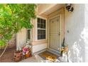 Inviting front porch with a security screen door, flowers, and shade from a tree at 8505 Lansdale Rd, Las Vegas, NV 89123