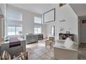 Bright living room with high ceilings, large windows, and tile flooring offers plenty of natural light at 9348 Buckhaven Dr, Las Vegas, NV 89117