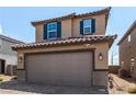 Attractive home features a brick driveway, well-maintained landscaping, and a two-car garage, creating a welcoming entrance at 9690 Langden Brook St, Las Vegas, NV 89178