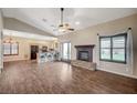 Open living space with tile floors, gas fireplace, vaulted ceilings, and adjoining kitchen with breakfast bar at 983 Cutter St, Henderson, NV 89011