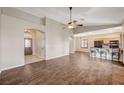 Spacious open floor plan with tile floors, leading to the kitchen with stainless appliances and breakfast bar seating at 983 Cutter St, Henderson, NV 89011