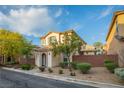 Well-maintained home featuring desert landscaping, a tiled roof, and an inviting arched entryway at 11044 Camden Bay St, Las Vegas, NV 89179