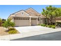 Charming single-story home featuring a three-car garage and manicured landscaping at 2164 Noonday Ct, Henderson, NV 89052