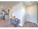 Welcoming entryway with modern bench, green accent wall, and view into the kitchen at 2646 Begonia Falls Ave # 41, North Las Vegas, NV 89081