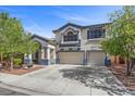 Charming two-story home with a landscaped front yard and a spacious driveway leading to a two-car garage at 2717 Cool Lilac Ave, Henderson, NV 89052