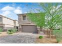 Charming two-story home featuring a well-manicured yard and a two-car garage on a beautiful, sunny day at 311 Lilian Faith Ave, North Las Vegas, NV 89031