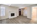 Inviting living room with vinyl floors, fireplace, and natural light from window at 3683 Villa Knolls East Dr, Las Vegas, NV 89120