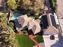 Bird's eye view of the residential house featuring pool, solar panels, and extensive yard at 4075 E Oquendo Rd, Las Vegas, NV 89120
