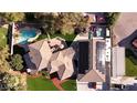 Overhead view of the house showcasing the tile roof, pool, solar panels, and green backyard at 4075 E Oquendo Rd, Las Vegas, NV 89120