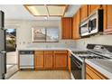 Functional kitchen with wood cabinets, white countertops, and standard appliances at 433 Old Palms Dr, Las Vegas, NV 89123