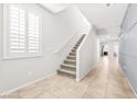 Bright staircase with carpeted steps and white trim, complemented by neutral-toned walls at 4519 Stardusk Falls Ave, North Las Vegas, NV 89084