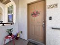 Inviting front door with a 'Welcome' wreath, and a well-kept entry area at 50 Aura De Blanco St # 18204, Henderson, NV 89074