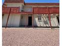 Exterior of unit 27 with red support beams and a small upper balcony at 5390 Swenson St # 27, Las Vegas, NV 89119