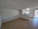 Open-concept living area with tile flooring and views into the kitchen space at 5390 Swenson St # 27, Las Vegas, NV 89119
