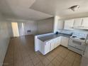 Open living room and kitchen space featuring tile floors and bright white walls at 5390 Swenson St # 27, Las Vegas, NV 89119