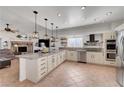 Spacious kitchen with granite countertops, stainless steel appliances, and modern pendant lighting at 5725 N Durango Dr, Las Vegas, NV 89149