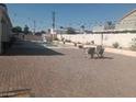 Spacious backyard with a patio, chairs, and a pool in the background at 60 N Fogg St, Las Vegas, NV 89110