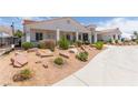 Charming single-story house with xeriscaping, long driveway, and mature landscaping at 60 N Fogg St, Las Vegas, NV 89110