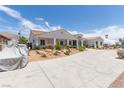 Attractive single-story home featuring an expansive driveway and low-maintenance landscaping at 60 N Fogg St, Las Vegas, NV 89110