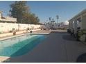 A private in-ground pool surrounded by a concrete deck in the backyard at 60 N Fogg St, Las Vegas, NV 89110