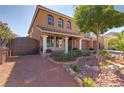 Beautiful two-story home with desert landscaping, a covered front porch, and a private gated driveway at 6403 Brandon Hills Ct, Las Vegas, NV 89139