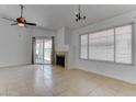 Bright living room featuring tile floors, a fireplace, and a sliding glass door leading to the backyard at 6624 Old Oxford Ave, Las Vegas, NV 89108