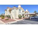 Well-maintained condo complex with lush landscaping, covered parking, and inviting walkways in a vibrant community at 698 S Racetrack Rd # 1014, Henderson, NV 89015