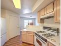 Functional kitchen featuring ample counter space, wood cabinets, and essential appliances for easy meal preparation at 698 S Racetrack Rd # 1014, Henderson, NV 89015